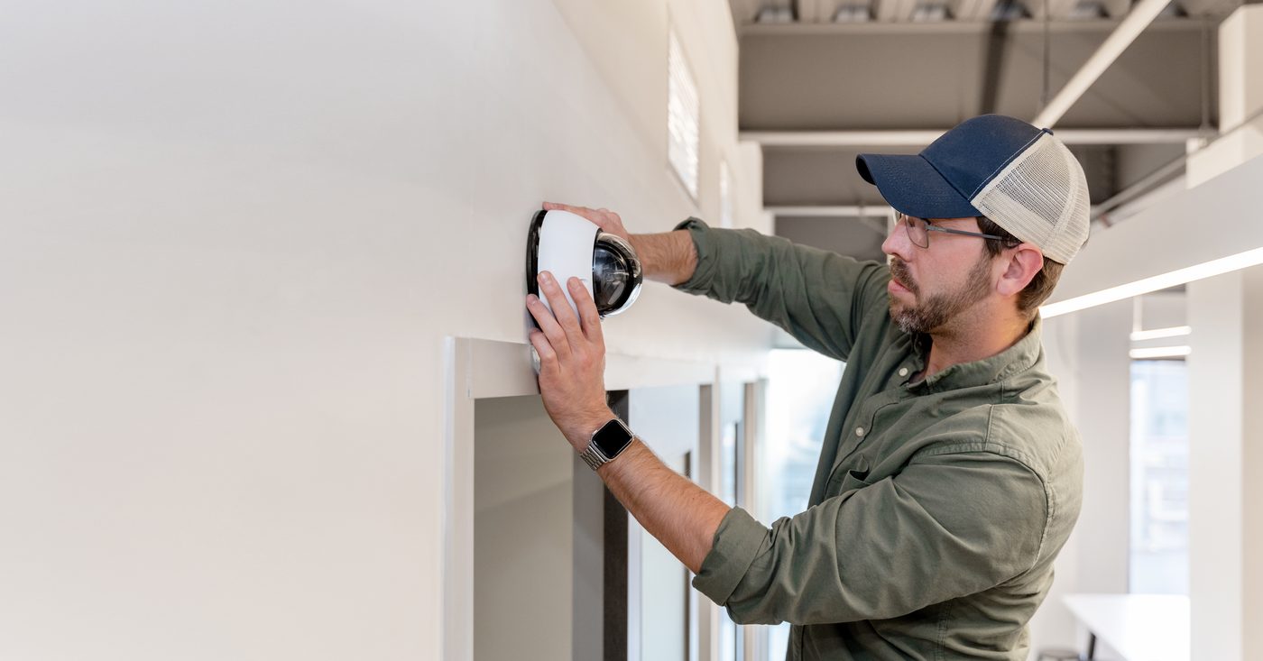 A dome camera being installed to a ceiling