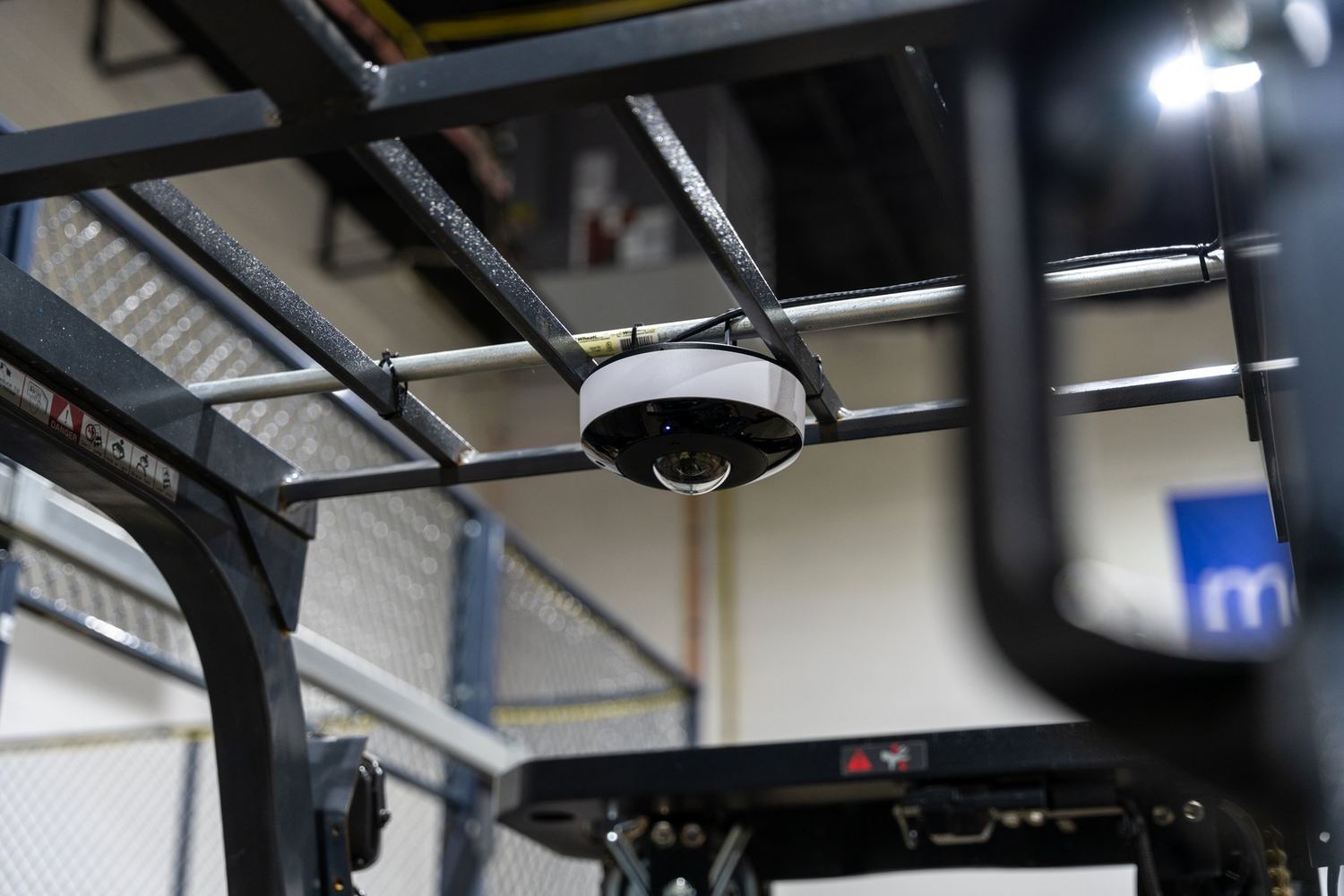 A fisheye camera above warehouse racking